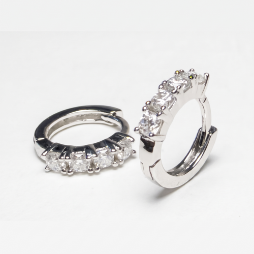 AnastasiaRio moissanite huggie hoop earrings in rhodium-plated 925 sterling silver, four round moissanite stones, on white