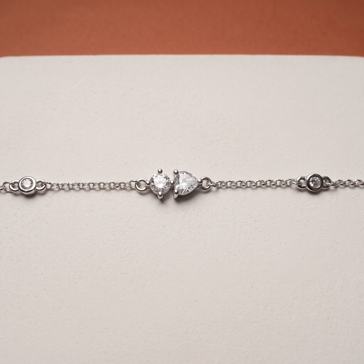 Toi et moi moissanite bracelet on a plaster slab against terracotta