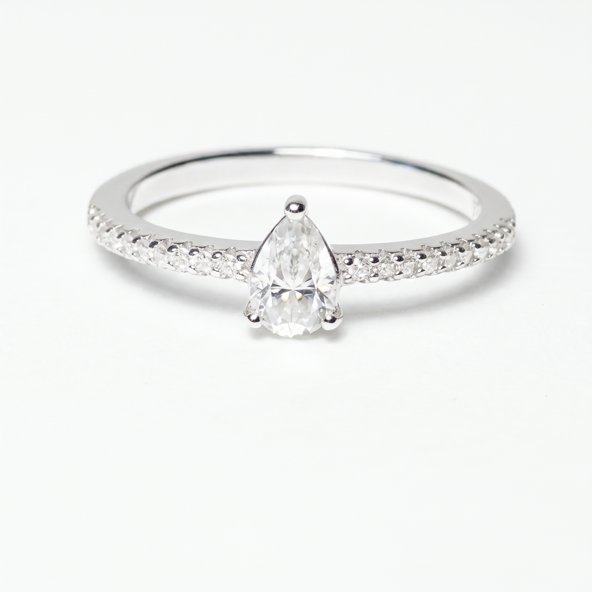 Pear moissanite ring, front view on white