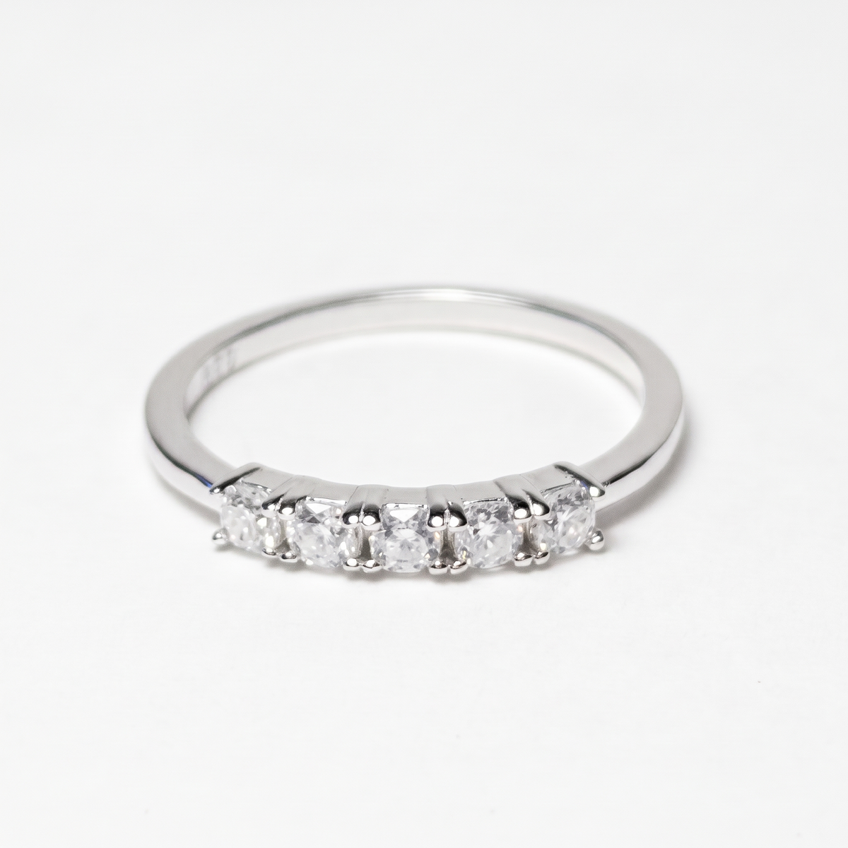 Five-stone moissanite ring, front view on white
