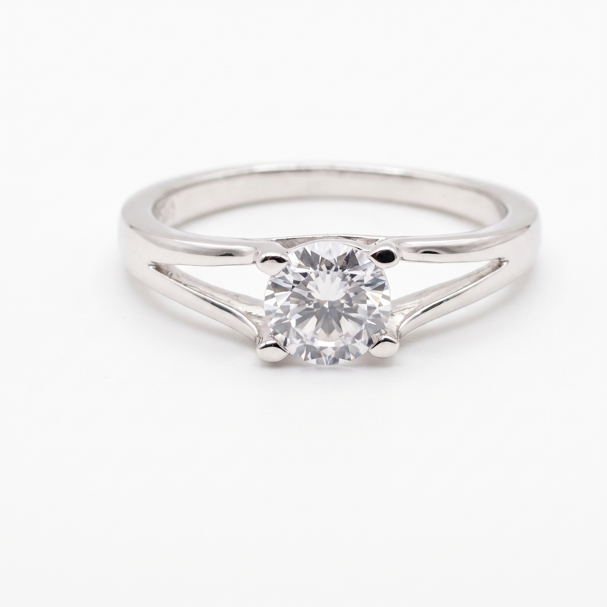 Split-shank moissanite solitaire, front view on white